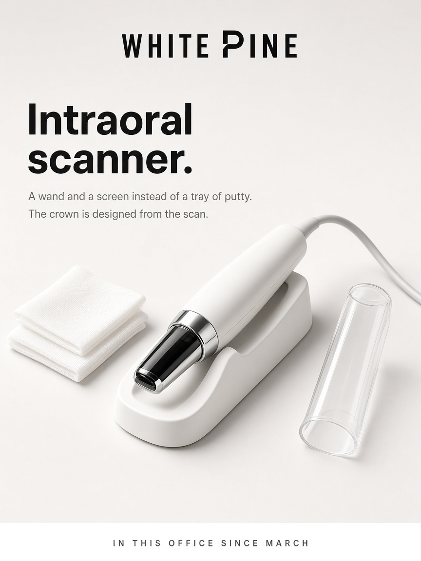 White Pine Dental post: "Intraoral scanner.", a matte white scanner wand resting in its cradle on a high key white studio sweep.