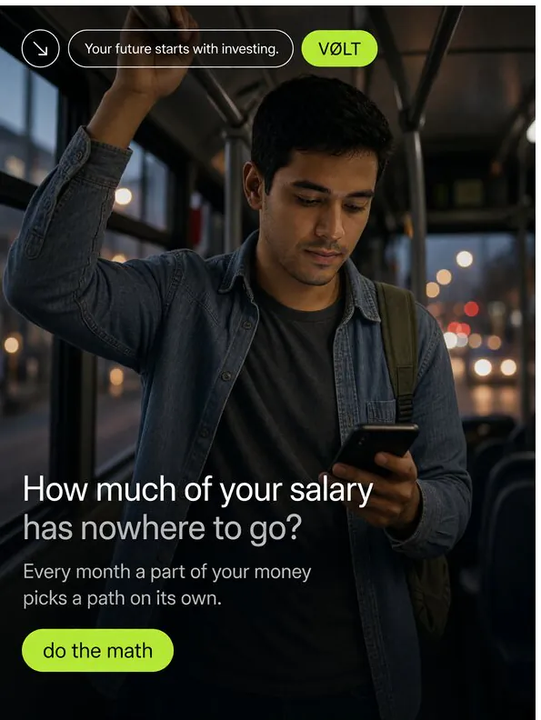 Volt: ‘How much of your salary has nowhere to go?’: a commuter reading his phone on a bus at dusk.